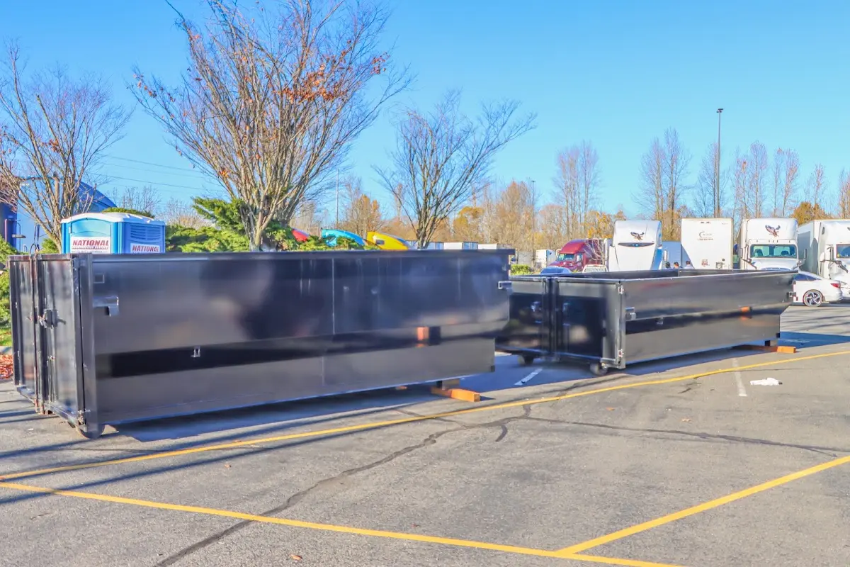 Professional dumpster rental service with roll-off container on residential driveway in Mount Holly